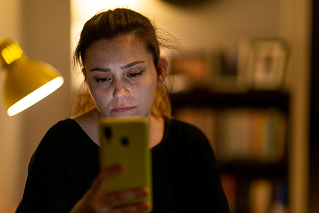 Patient communications - girl looking at SMS on phone